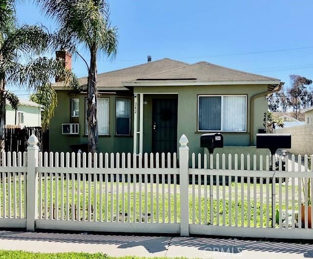 242 E 116th St, Los Angeles, CA 90061 - bungalow-style home with roof with shingles, a fenced front yard, and stucco siding