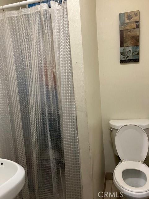 242 E 116th St, Los Angeles, CA 90061 - full bathroom with toilet and baseboards