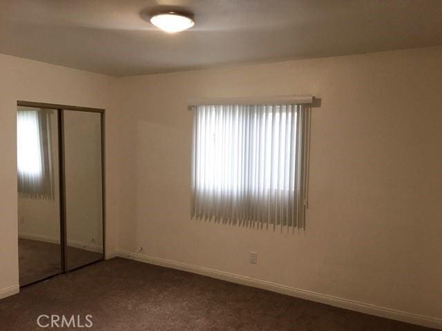 242 E 116th St, Los Angeles, CA 90061 - unfurnished bedroom featuring a closet, carpet flooring, and baseboards