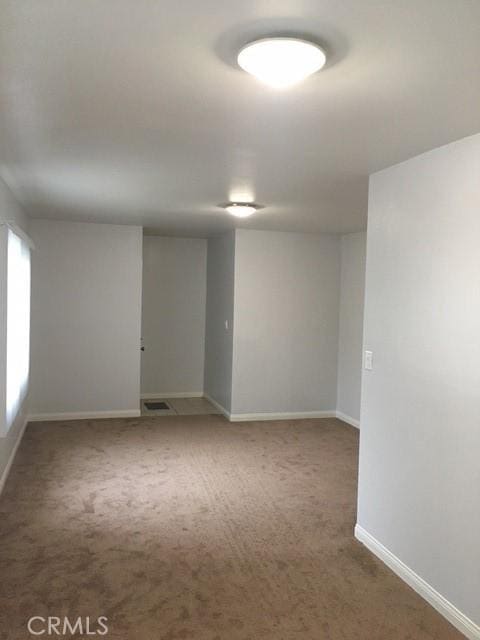 242 E 116th St, Los Angeles, CA 90061 - carpeted empty room featuring baseboards