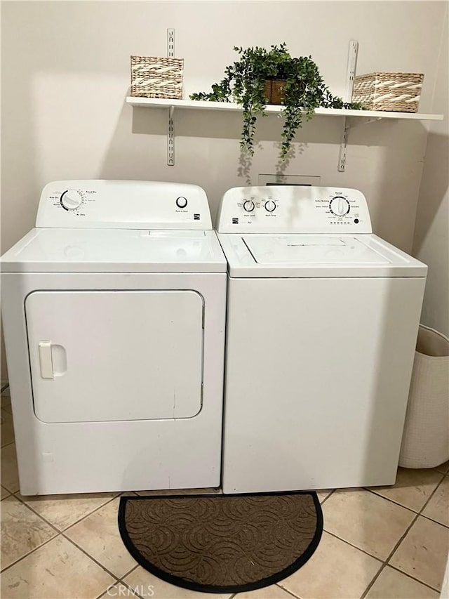 242 E 116th St, Los Angeles, CA 90061 - laundry room with light tile patterned flooring, washer and dryer, and laundry area