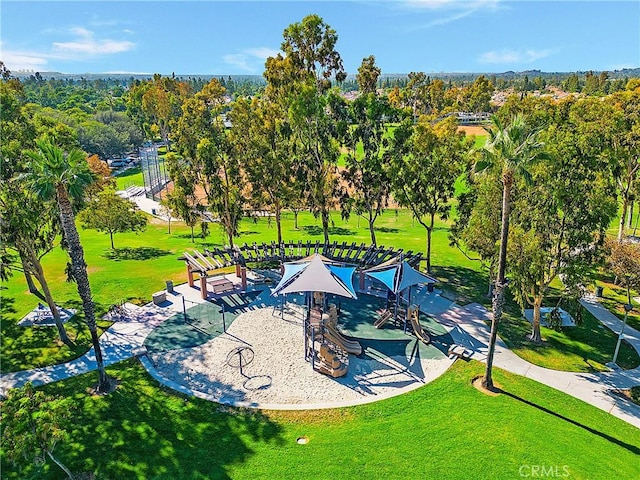 view of property's community with a lawn and playground community