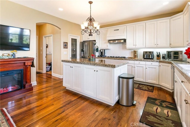 1251 Kodiak Dr, Lake Arrowhead, CA 92352 - kitchen featuring stainless steel fridge with ice dispenser, a kitchen island, dark wood-type flooring, white cabinetry, and a chandelier
