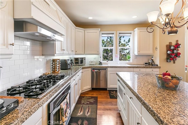 1251 Kodiak Dr, Lake Arrowhead, CA 92352 - kitchen featuring stainless steel dishwasher, dark wood-type flooring, oven, black gas cooktop, and a chandelier