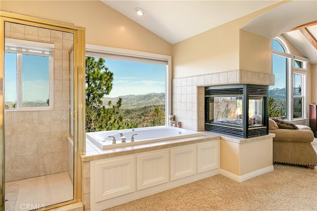1251 Kodiak Dr, Lake Arrowhead, CA 92352 - bathroom with vaulted ceiling, a stall shower, a bath, a mountain view, and a fireplace