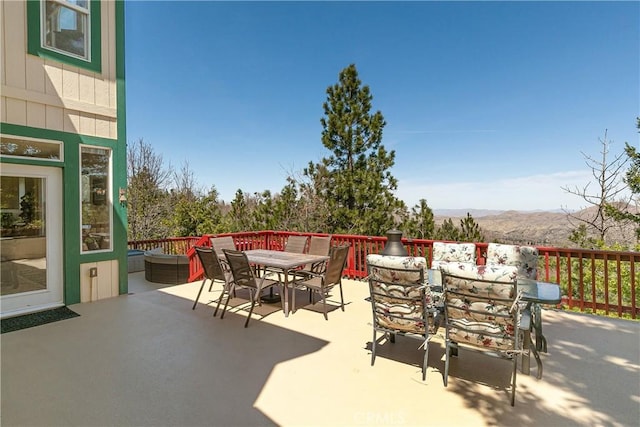 1251 Kodiak Dr, Lake Arrowhead, CA 92352 - view of patio / terrace with outdoor dining space and a mountain view