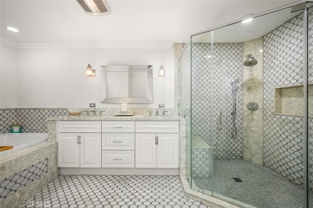 bathroom with crown molding, a shower stall, a bath, and double vanity