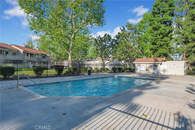 community pool featuring a patio area and fence