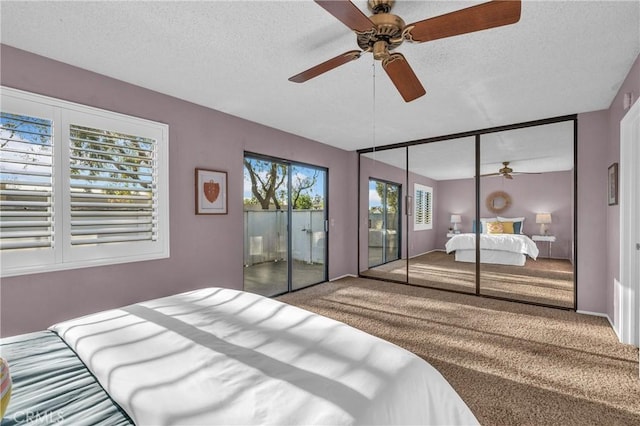 carpeted bedroom with access to exterior, a ceiling fan, and a textured ceiling