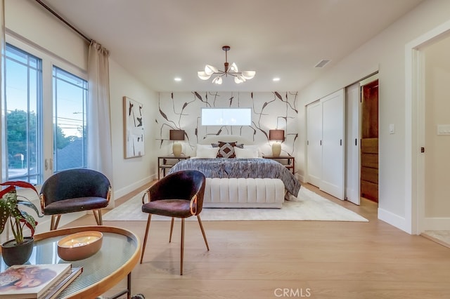 4903 Spencer St, Torrance, CA 90503 - bedroom featuring an accent wall, multiple windows, a chandelier, and wood finished floors