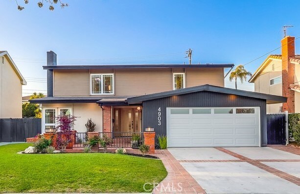4903 Spencer St, Torrance, CA 90503 - traditional-style home with a front lawn, fence, a garage, and concrete driveway
