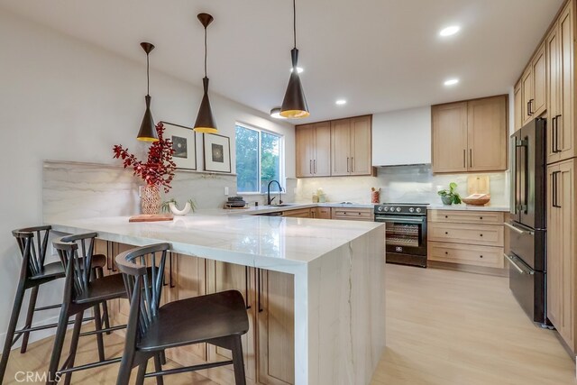 4903 Spencer St, Torrance, CA 90503 - kitchen with custom exhaust hood, a peninsula, light stone countertops, range with electric cooktop, and high quality fridge