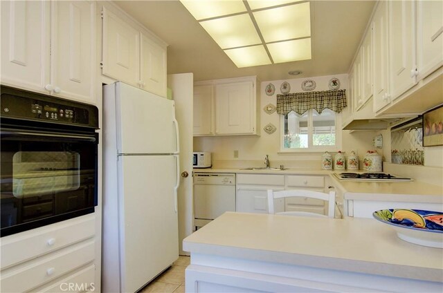 606 Avenida Sevilla Unit O, Laguna Woods, CA 92637 - kitchen with a sink, light countertops, white cabinetry, and white appliances