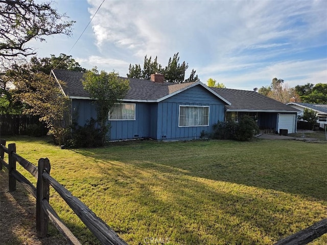 view of front facade featuring board and batten siding, a front lawn, fence, and an attached garage