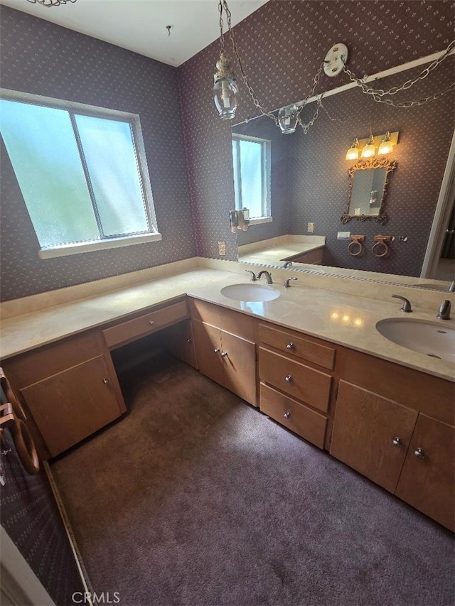 full bath with wallpapered walls, a sink, and double vanity