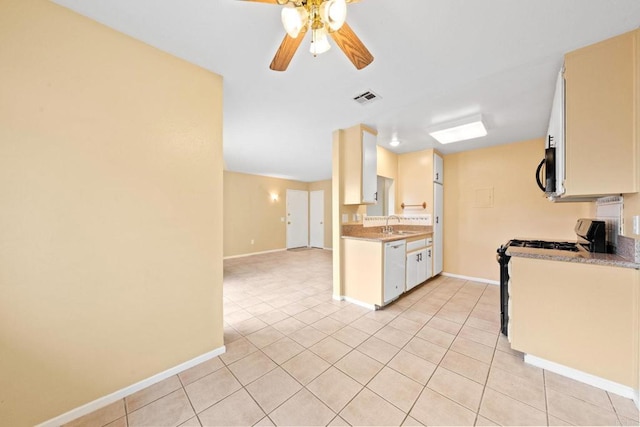 kitchen with dishwasher, visible vents, baseboards, and ceiling fan