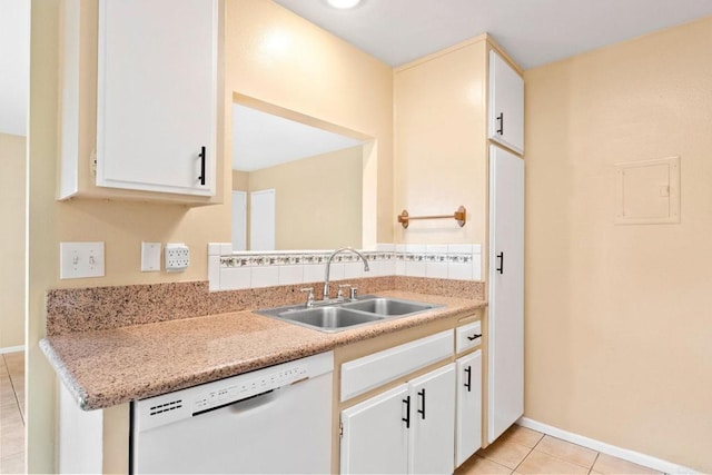 kitchen featuring white dishwasher, light countertops, a sink, and light tile patterned floors