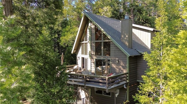 229 Chippewa Ln, Lake Arrowhead, CA 92352 - back of property featuring roof with shingles, a deck, and a chimney