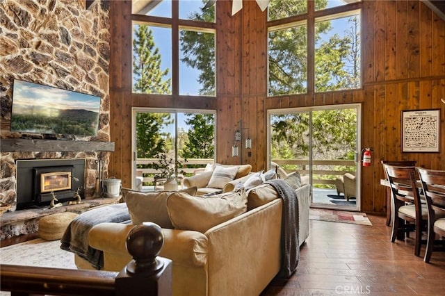 229 Chippewa Ln, Lake Arrowhead, CA 92352 - living area featuring high vaulted ceiling, wooden walls, hardwood / wood-style flooring, and a stone fireplace