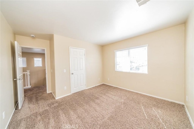 unfurnished bedroom with baseboards and carpet floors
