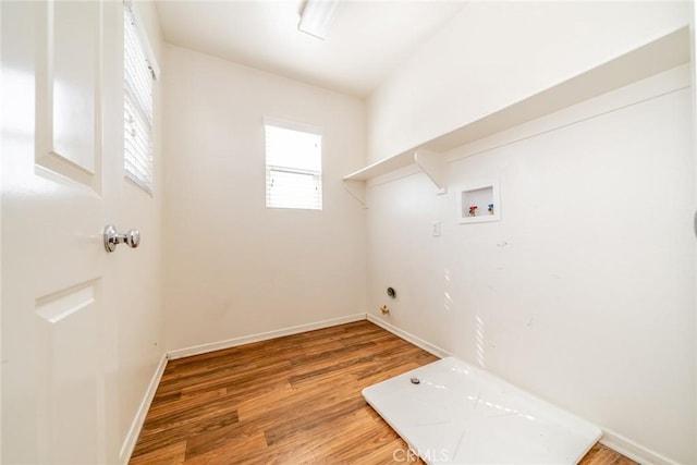 washroom with laundry area, light wood-style floors, hookup for a washing machine, gas dryer hookup, and baseboards