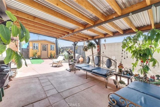view of patio / terrace with an outbuilding and a fenced backyard