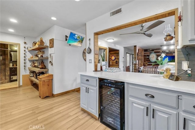 bar featuring recessed lighting, light wood-style flooring, visible vents, ceiling fan, and beverage cooler