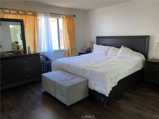 13501 Driftwood Dr, Victorville, CA 92395 - bedroom with dark wood-style flooring and a textured ceiling