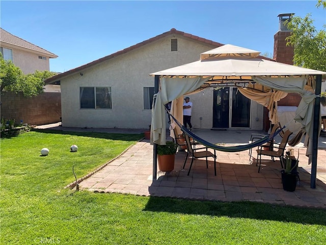 13501 Driftwood Dr, Victorville, CA 92395 - back of house featuring a gazebo, a lawn, fence, a patio, and stucco siding