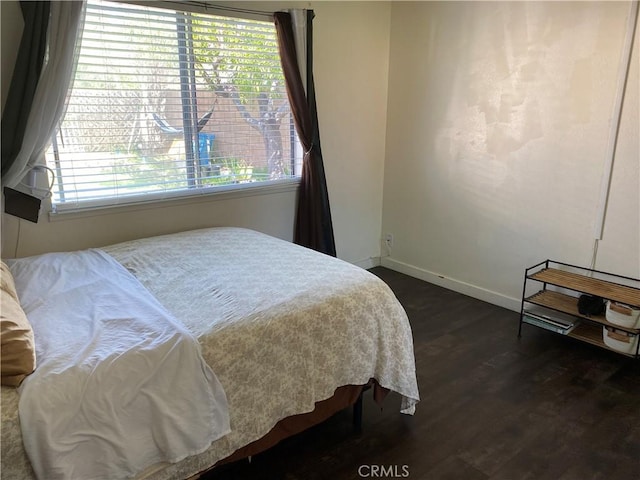 13501 Driftwood Dr, Victorville, CA 92395 - bedroom with dark wood-style flooring and baseboards