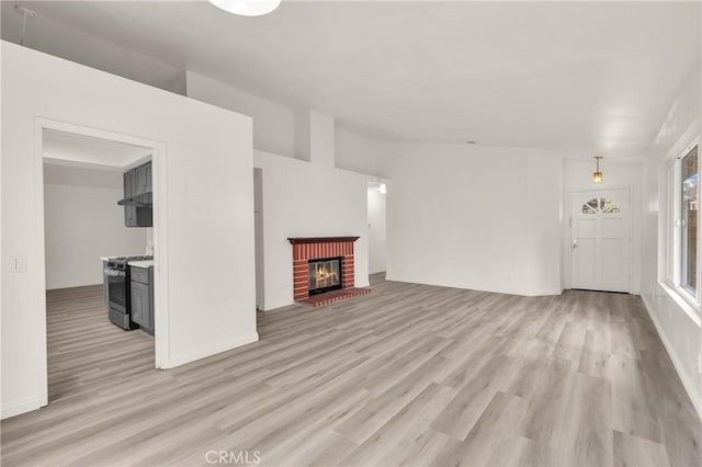 unfurnished living room featuring a fireplace and light wood-style floors