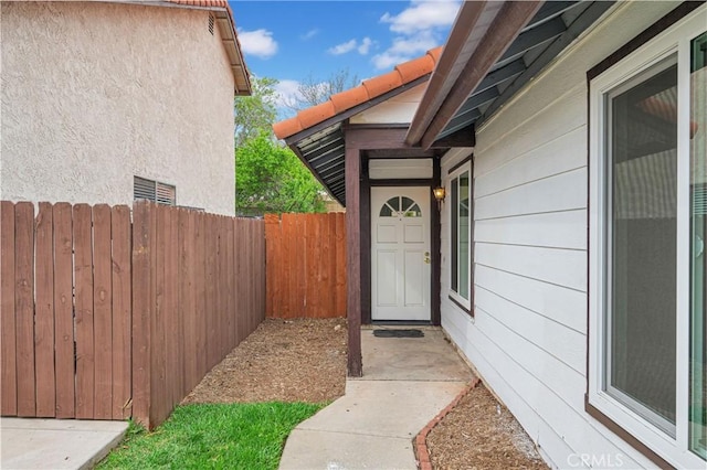 entrance to property featuring fence