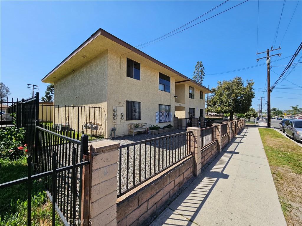 view of home's exterior with fence, a gate, and stucco siding