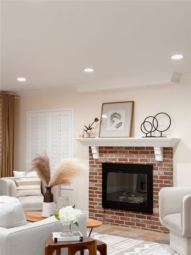 living room with a fireplace, ornamental molding, and recessed lighting