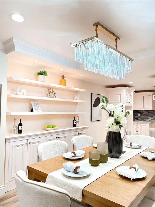 dining room featuring recessed lighting, light wood-style floors, and crown molding