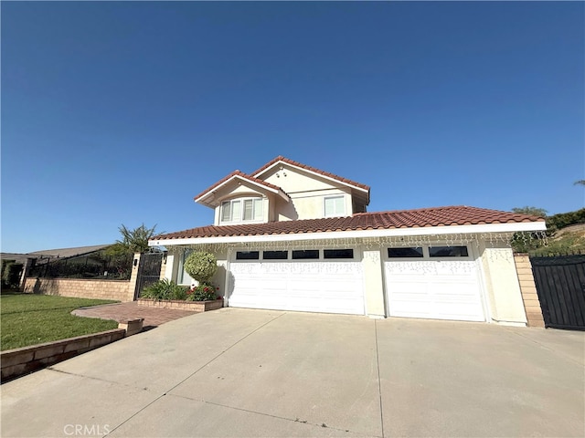 view of front facade featuring a tiled roof, a garage, stucco siding, fence, and driveway