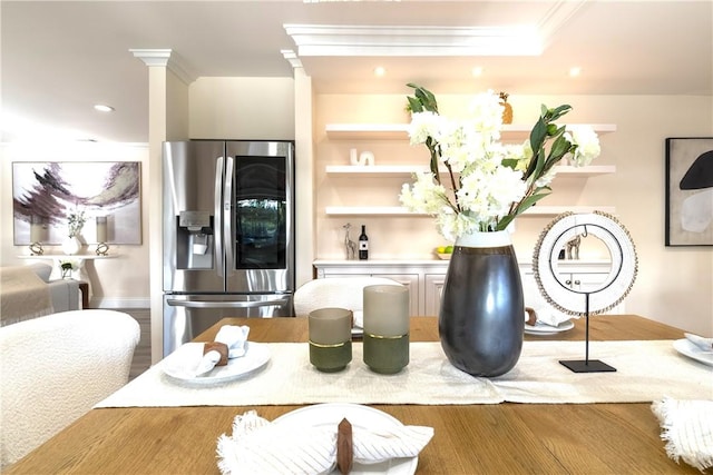 dining room with crown molding, wood finished floors, ornate columns, and recessed lighting