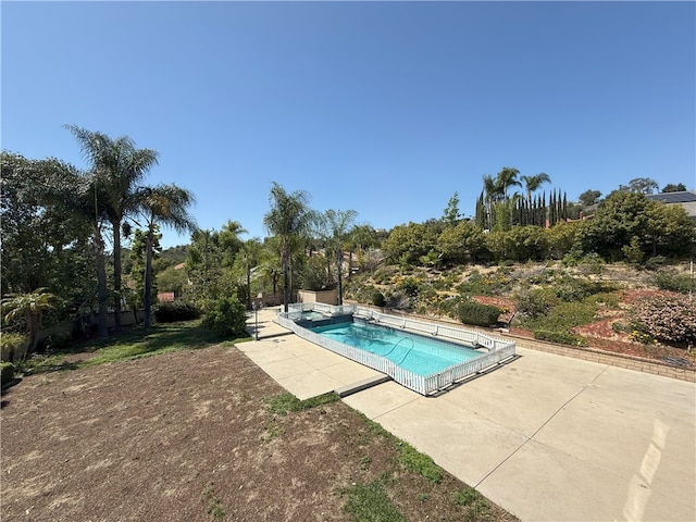 view of swimming pool with a patio area and a pool with connected hot tub