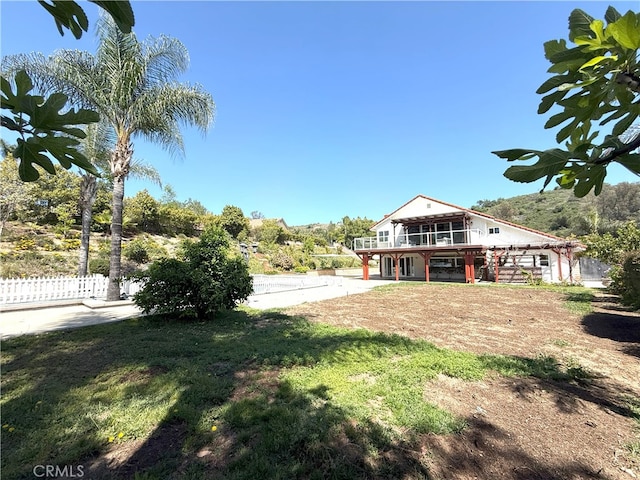 view of yard with fence and a sunroom