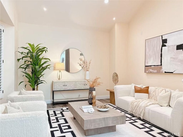 living area with baseboards, recessed lighting, and wood finished floors