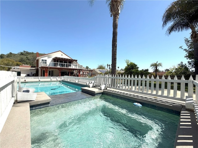 view of pool with a fenced in pool and fence