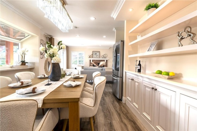 dining space featuring ornamental molding, recessed lighting, and dark wood finished floors