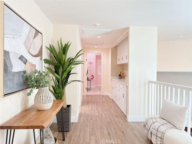 hallway featuring baseboards and light wood-style floors