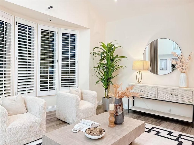 living area featuring baseboards and wood finished floors