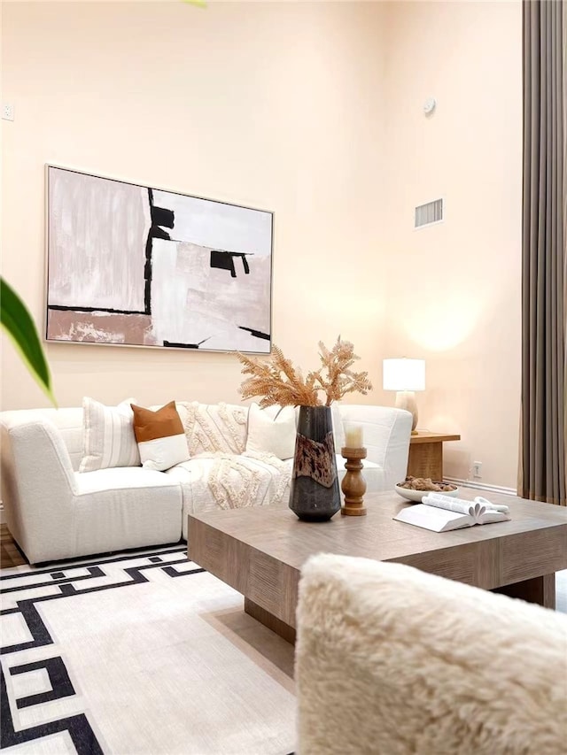 living room with a high ceiling and visible vents