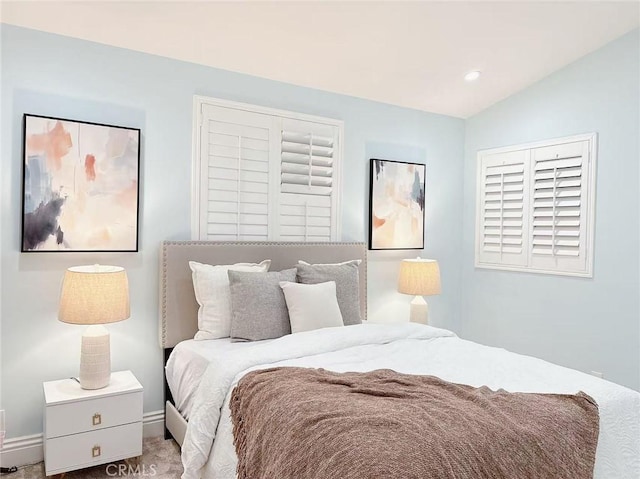carpeted bedroom featuring baseboards, lofted ceiling, and recessed lighting