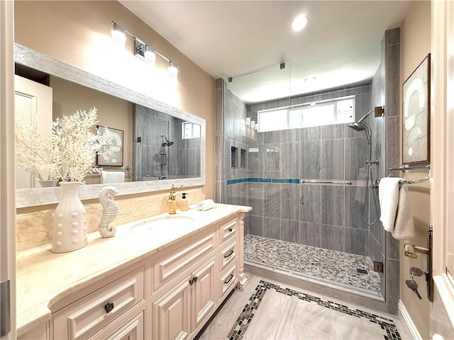 full bath with tile patterned floors, vanity, and a stall shower