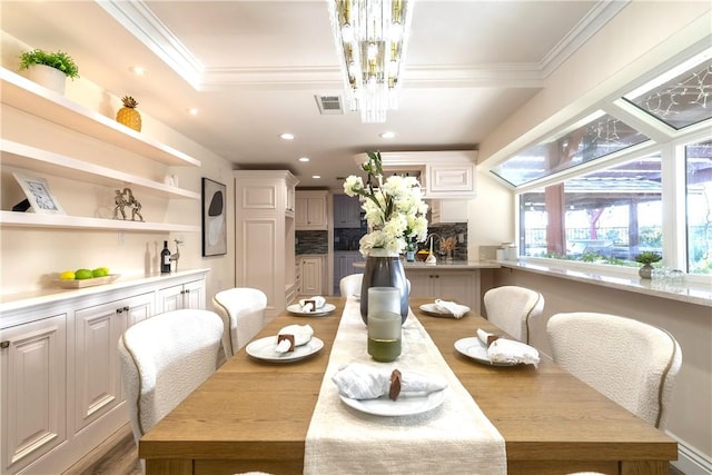 dining area with crown molding, visible vents, recessed lighting, and an inviting chandelier