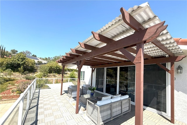 view of patio / terrace with a pergola and a balcony