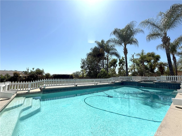 view of pool with a fenced in pool and fence